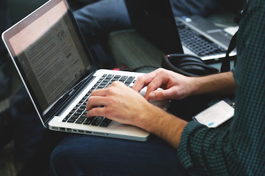 hands on laptop keyboard