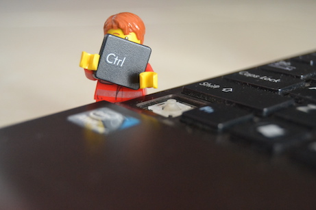 lego figure in front of a computer keyboard
